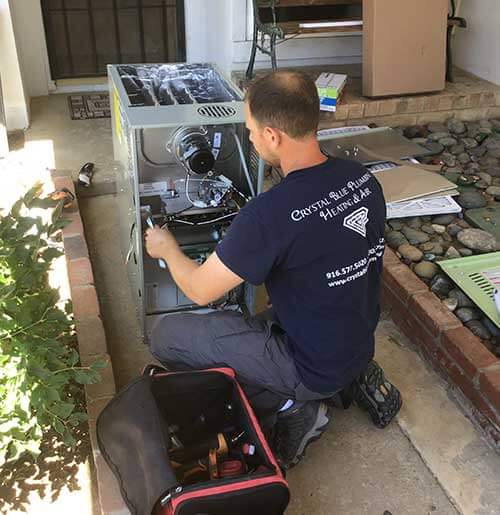 Technician unwrapping new air conditioner