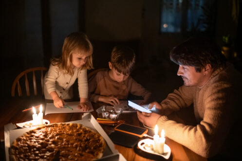 A dad and kids spending time together during a blackout